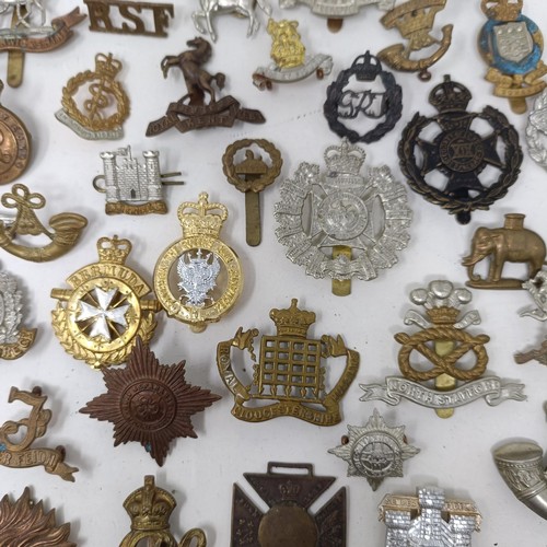 989 - Assorted military cap and other badges