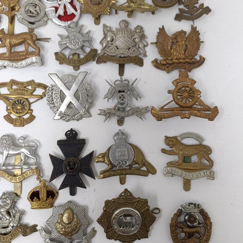 990 - Assorted military cap and other badges