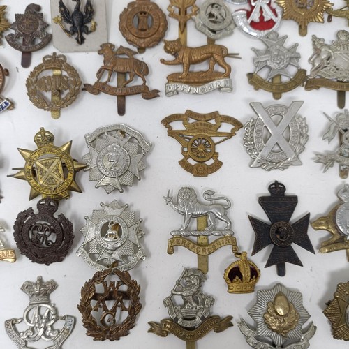 990 - Assorted military cap and other badges