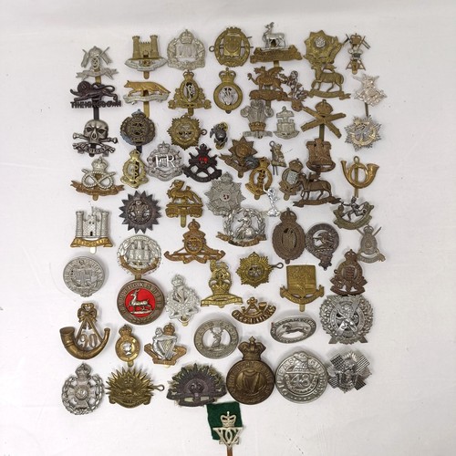 991 - Assorted military cap and other badges