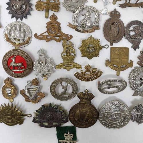 991 - Assorted military cap and other badges