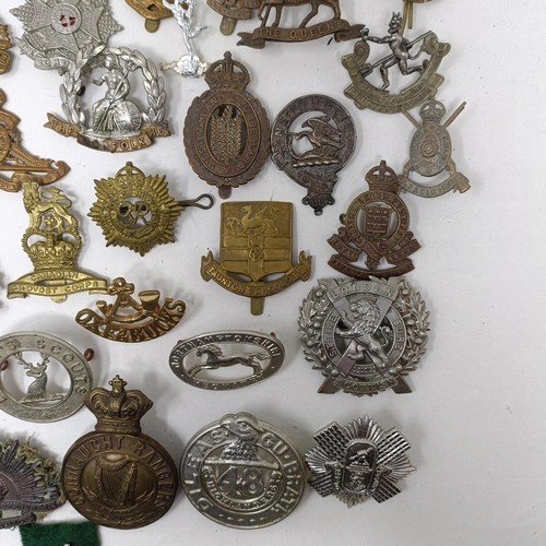 991 - Assorted military cap and other badges