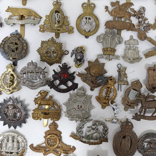 991 - Assorted military cap and other badges