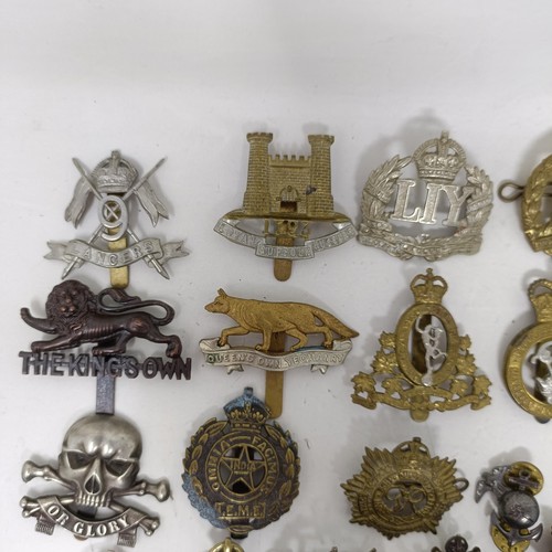 991 - Assorted military cap and other badges