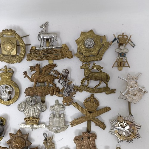 991 - Assorted military cap and other badges