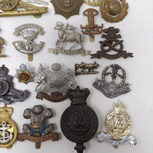 992 - Assorted military cap and other badges