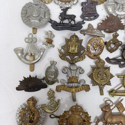 992 - Assorted military cap and other badges