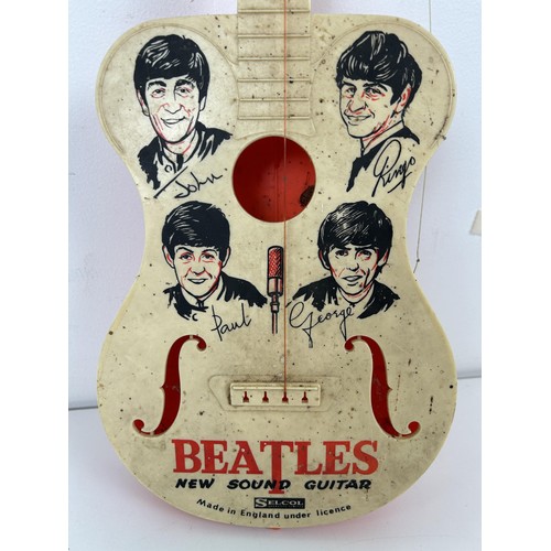 587 - A Beatles New Sound plastic guitar, by Selcol