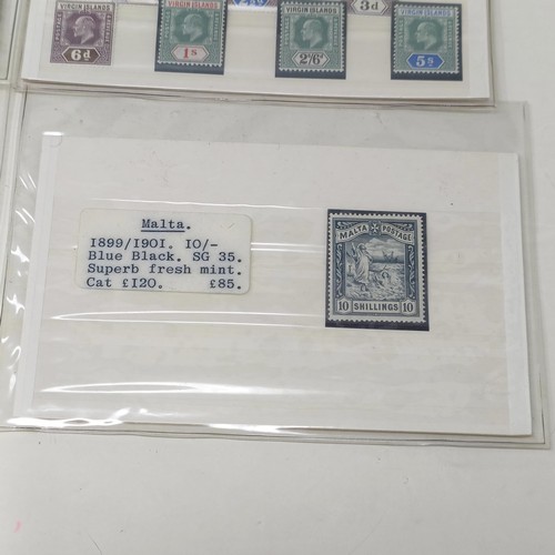 A Malta 10 shilling stamp, a set of Tanganyika stamps, 5c - £1, and a ...