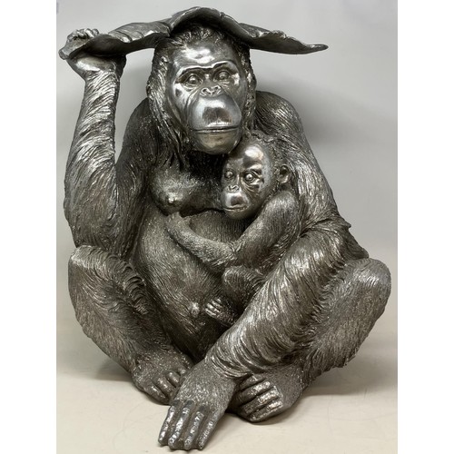 1306 - A silvered model of a orangutan, 48 cm high, and assorted blue and white balls (qty)