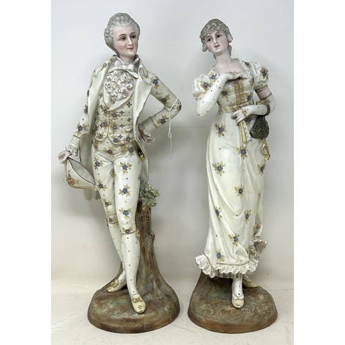 1354 - A pair of Continental figures, of a gentleman and a lady, 40 cm high, and a pair of floral encrusted... 