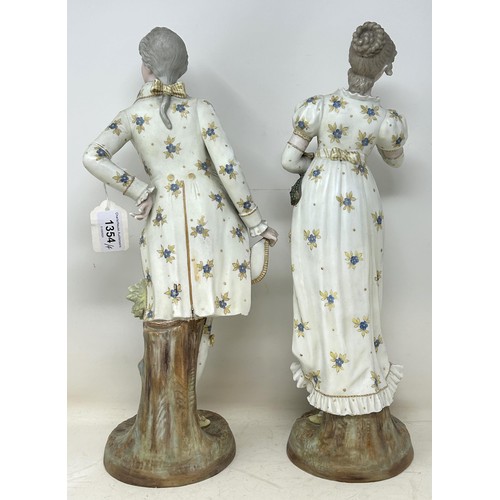 1354 - A pair of Continental figures, of a gentleman and a lady, 40 cm high, and a pair of floral encrusted... 