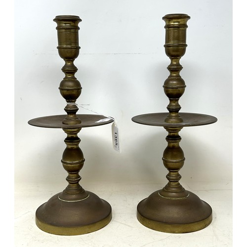 1365 - A pair of Dutch 17th century style brass candlesticks, with wide drip pans, 30 cm high (2)