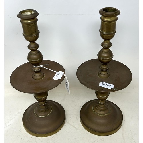 1365 - A pair of Dutch 17th century style brass candlesticks, with wide drip pans, 30 cm high (2)