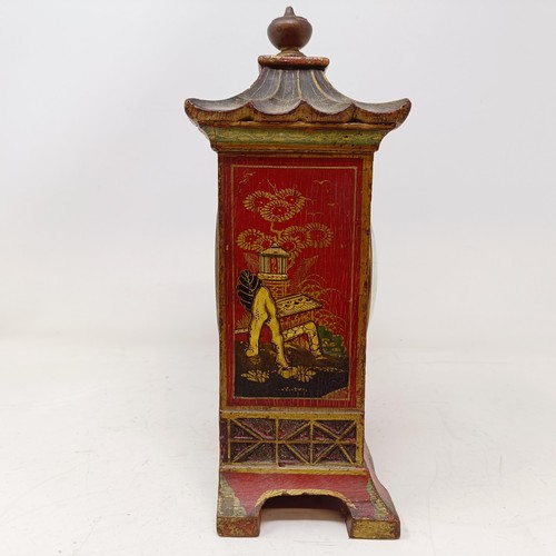 1506 - A mantel clock, with Arabic numerals, in a red case with Chinoiserie style decoration, 26 cm high