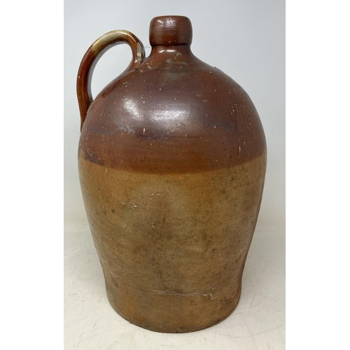 1326 - A stoneware flagon, 43 cm high, a large glass bottle, a suitcase filled with silver plated glass bot... 