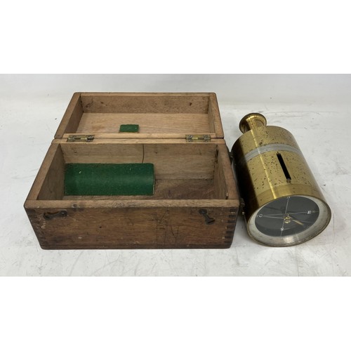 1329 - A brass hand held compass, 17 cm high, boxed, and four other compasses (5)