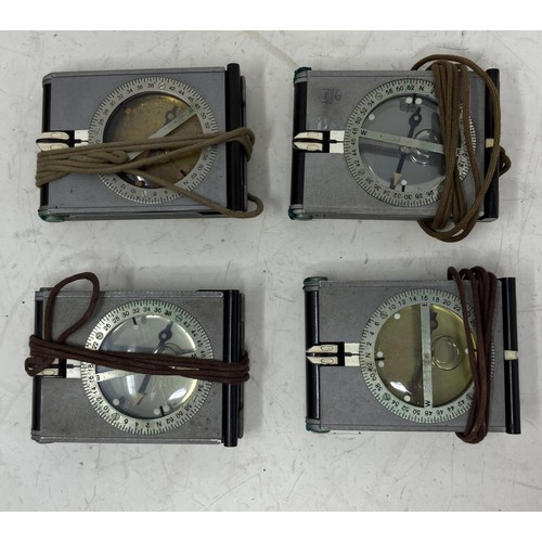 1329 - A brass hand held compass, 17 cm high, boxed, and four other compasses (5)