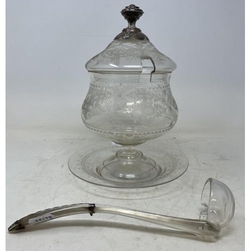 1335 - An etched glass bowl, cover, stand and ladle, with silver coloured metal mounts, 28 cm high (2)