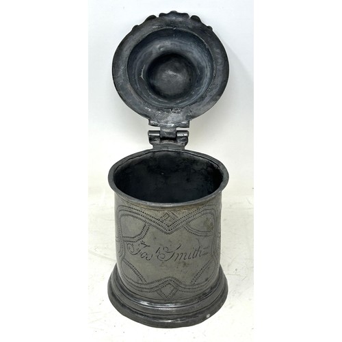 1339 - A 19th century pewter lidded tankard, inscribed Josh Smith, and with wrigglework decoration, 18 cm h... 