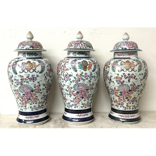 1342 - A Sampson 'Chinese Armorial' garniture of three vases, and covers, 40 cm high (3)