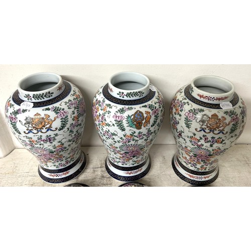 1342 - A Sampson 'Chinese Armorial' garniture of three vases, and covers, 40 cm high (3)