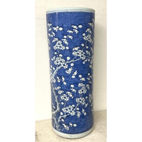 1350 - A Chinese cylindrical stick stand, decorated prunus in underglaze blue, cracked 60 cm high