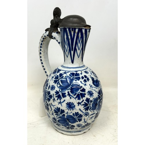 1371 - A Chinese pottery jug, with enamel decoration, 24.5 cm high, a Japanese Imari jug, with silver colou... 