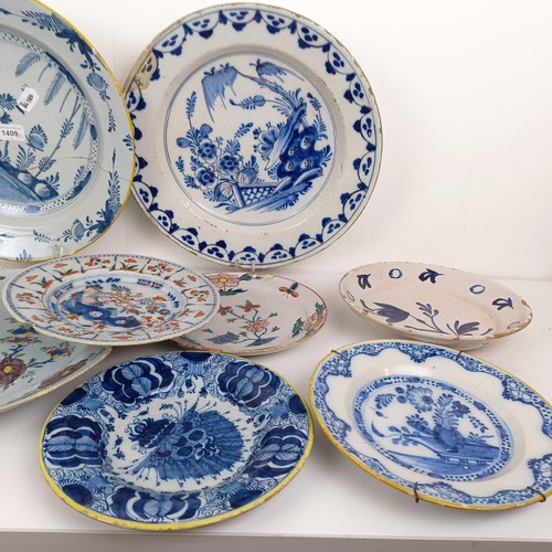 1409 - A Delft blue and white plate, 35 cm diameter, and assorted other Delft plates (12)