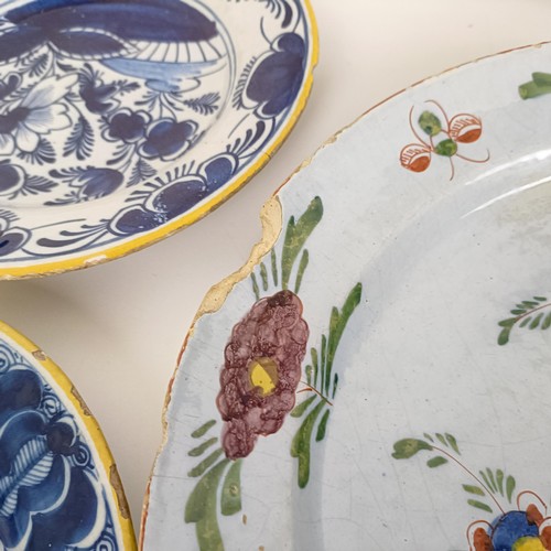 1409 - A Delft blue and white plate, 35 cm diameter, and assorted other Delft plates (12)