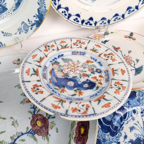 1409 - A Delft blue and white plate, 35 cm diameter, and assorted other Delft plates (12)