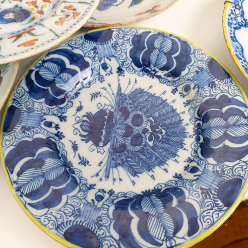 1409 - A Delft blue and white plate, 35 cm diameter, and assorted other Delft plates (12)