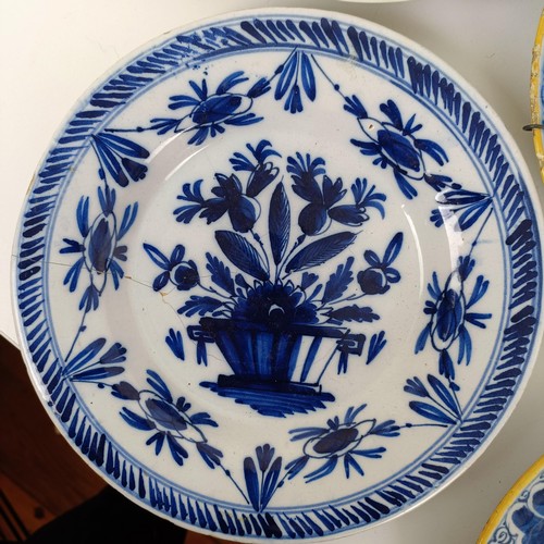 1411 - A Delft blue and white plate, 23 cm wide, and assorted other Delft plates (11)