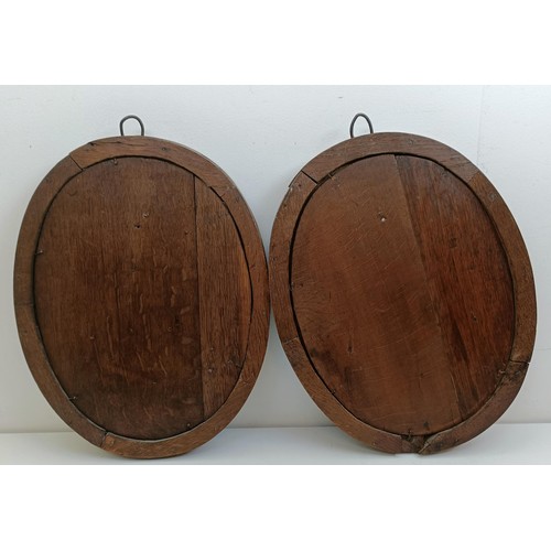 1424 - A pair of late 18th century carved oak oval panels, decorated bust portraits, 46 x 36 cm (2)