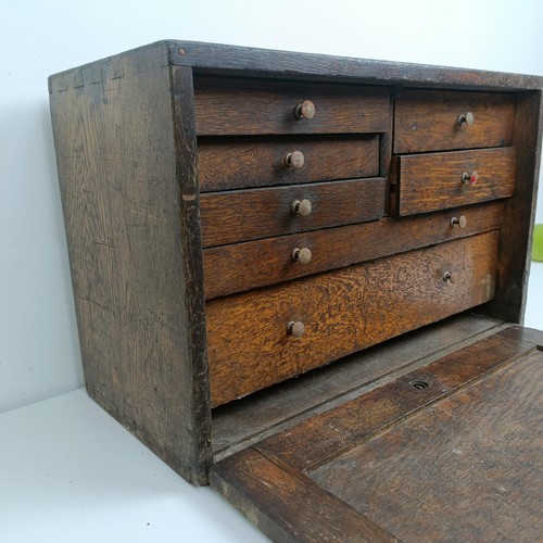 1498 - Assorted clock makers and other tools, in a cabinet 44 cm wide