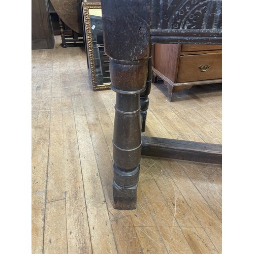 1652 - An 18th century style oak refectory table, the plank top above a carved frieze, 202 x 76 cm