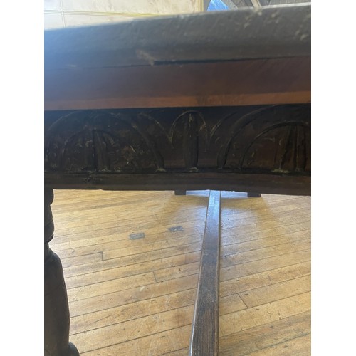 1652 - An 18th century style oak refectory table, the plank top above a carved frieze, 202 x 76 cm