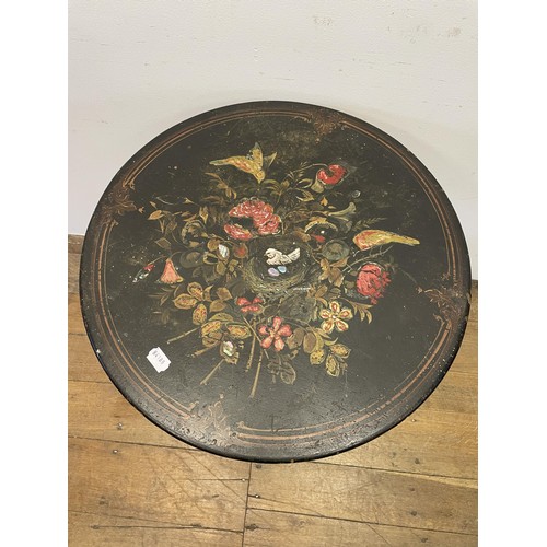 1604 - A black lacquered occasional table, decorated birds and flowers, 56 cm diameter