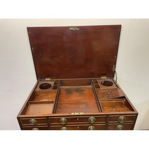 1665 - A 19th century mahogany dressing table, with a folding top revealing a fitted interior with an adjus... 