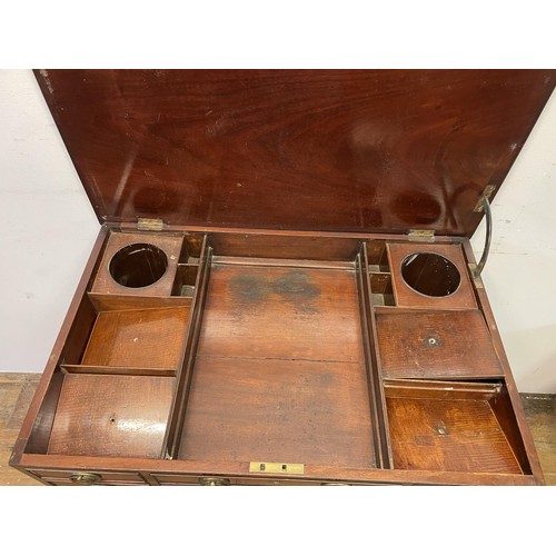 1665 - A 19th century mahogany dressing table, with a folding top revealing a fitted interior with an adjus... 