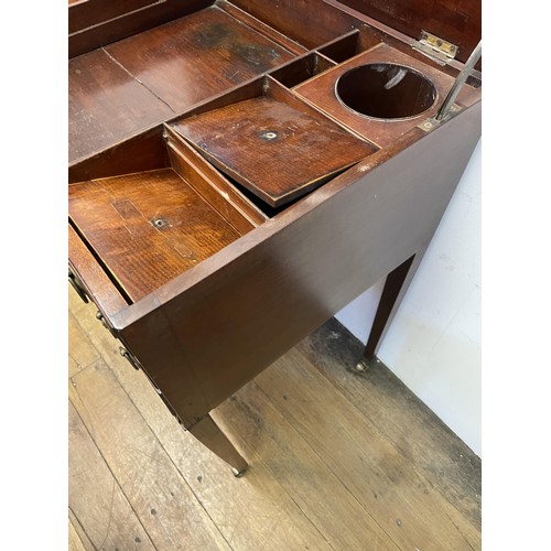 1665 - A 19th century mahogany dressing table, with a folding top revealing a fitted interior with an adjus... 