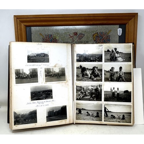 1383 - An early 20th century photograph album, with a carved wooden cover, contents of family portraits and... 