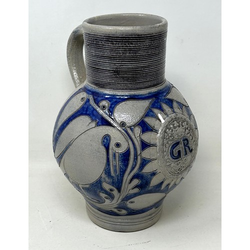 1444 - An 18th century German Westerwald stoneware jug, with GR cypher, 22 cm high