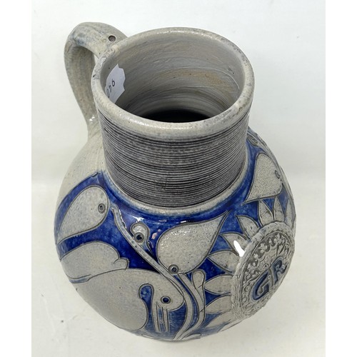 1444 - An 18th century German Westerwald stoneware jug, with GR cypher, 22 cm high