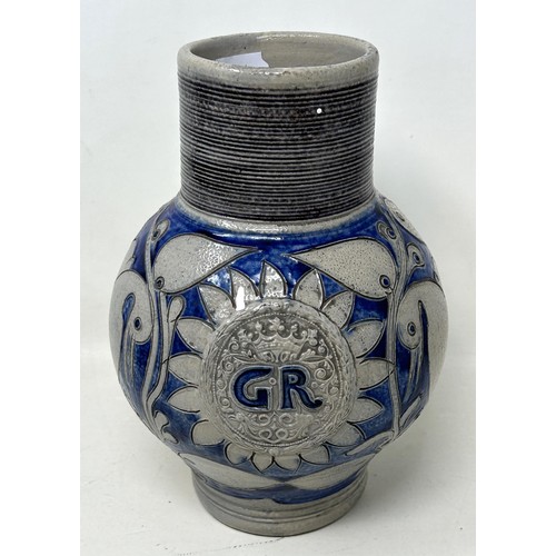 1444 - An 18th century German Westerwald stoneware jug, with GR cypher, 22 cm high