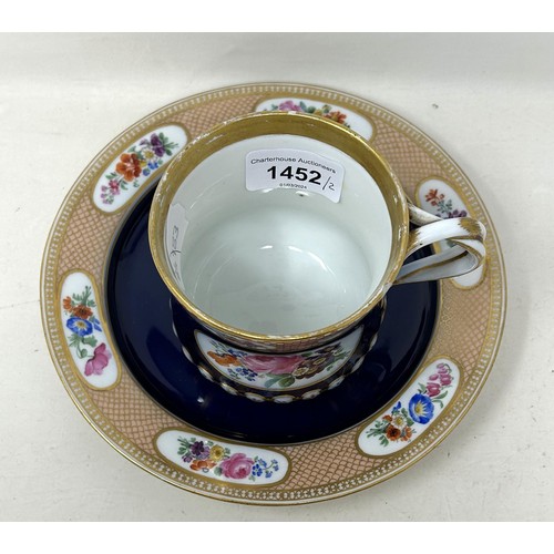 1452 - A late 19th century Meissen porcelain cup and a matching plate, with floral deocration on a blue gro... 