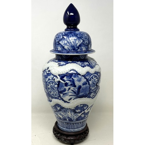 1460 - A Japanese blue and white vase and cover, on a stand, 38 cm high