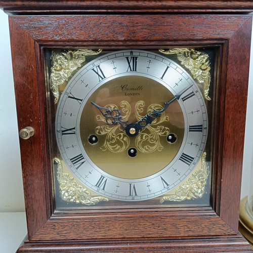 1522 - A reproduction mantel clock, in a mahogany case, 38 cm high, and three other clocks (4)