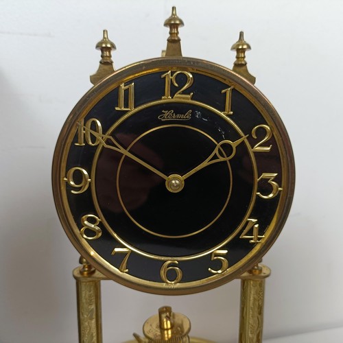 1522 - A reproduction mantel clock, in a mahogany case, 38 cm high, and three other clocks (4)