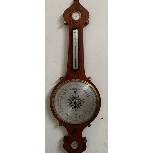 1524 - A Victorian wheel barometer, by J Hughes, London, with silvered dials, in a rosewood case, 114 cm hi... 